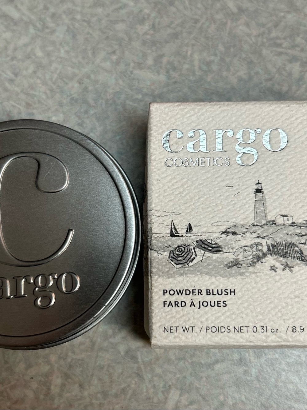 Cargo Cosmetics Powder Blush in Rome (peachy coral in color).